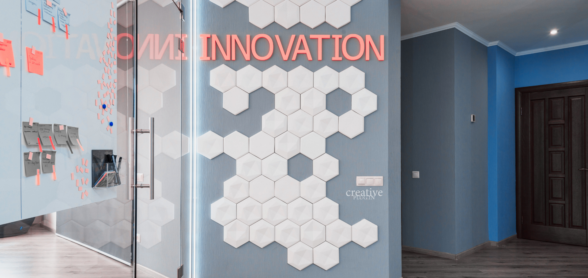 Wand mit hexagonalen Elementen und dem Text „CYBER INNOVATION“ in leuchtenden Farben.